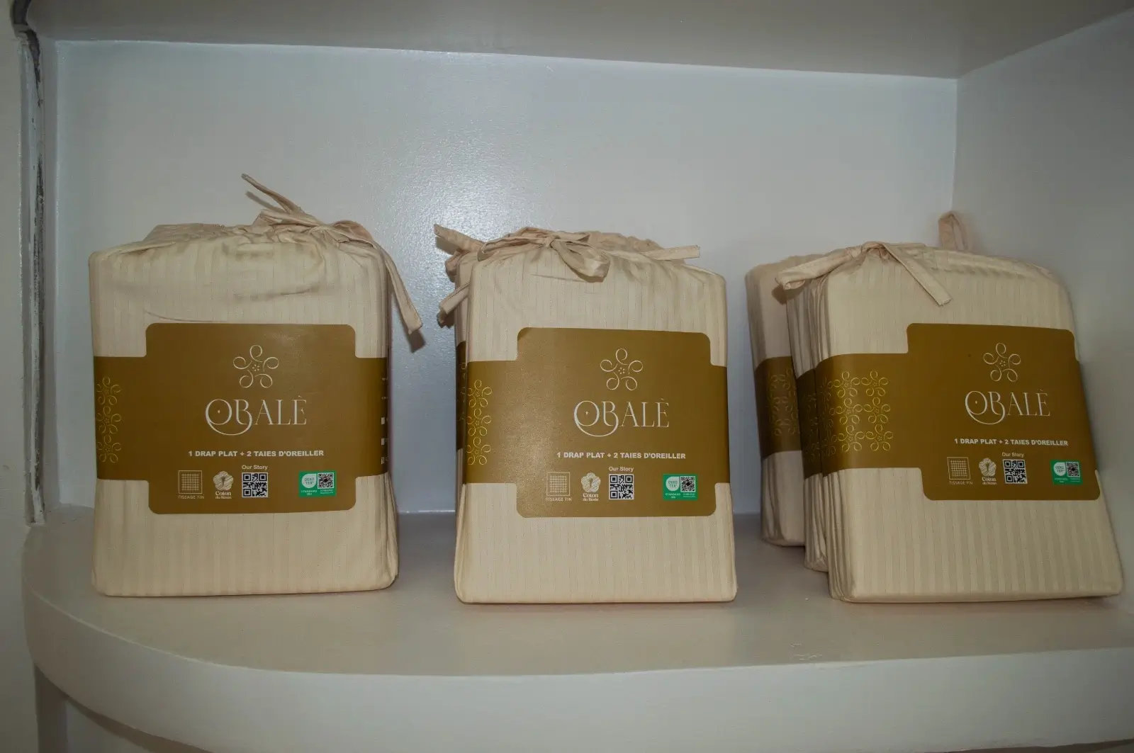 Obalè sheet sets, packaged with their brown and gold label